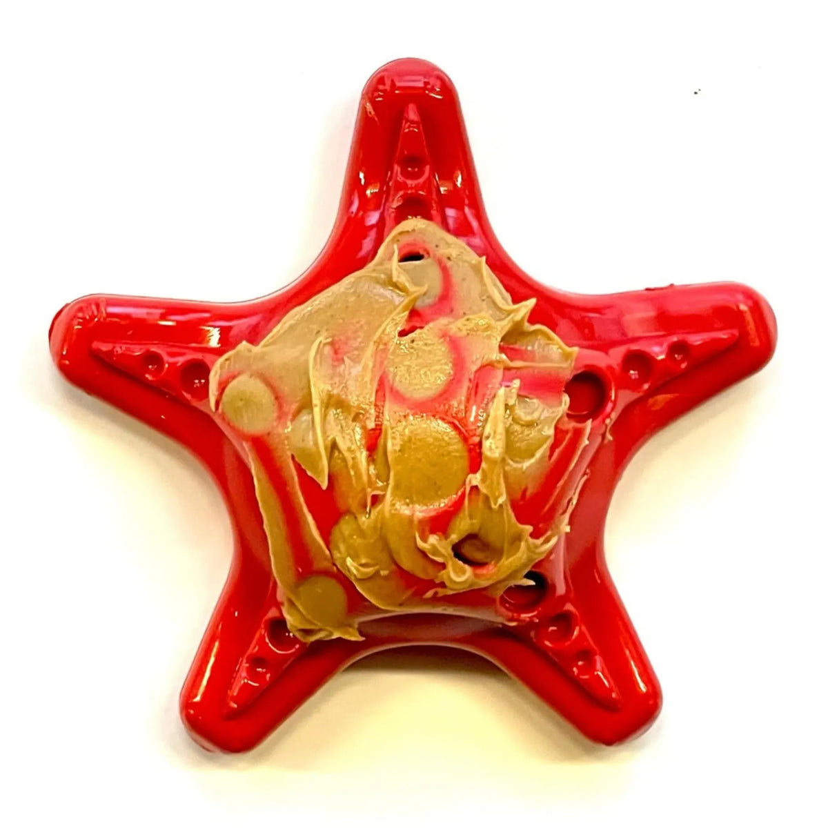 Red starfish-shaped dog toy filled with soft food